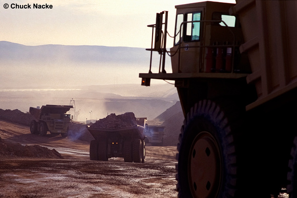 100 ton haul trucks at open pit gold mine, Round Mountain, NV