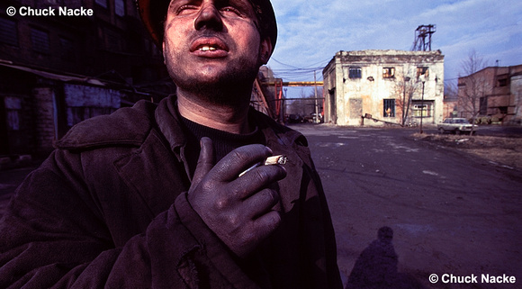 Russian Coal Miner smokes in the morning sun after his shift in the mine, Shakhty, RU